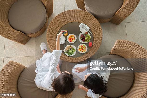 women friends at spa sharing healthy lunch and taking selfie - dubai fun stock pictures, royalty-free photos & images