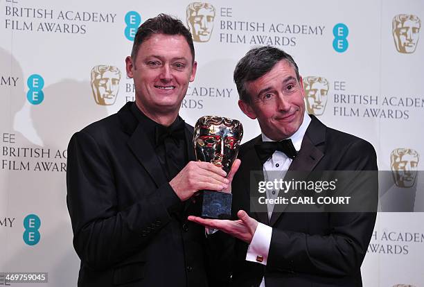 British writer, producer and actor Steve Coogan and British writer Jeff Pope pose with the award for an adapted screenplay for "Philomena" at the...