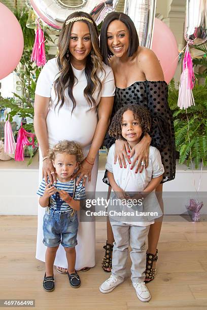 Tamera Mowry-Housley and Tia Mowry pose with sons Aden Housley and Cree Hardrict at Tamera Mowry-Housley's baby shower at Casa Del Mar on April 4,...