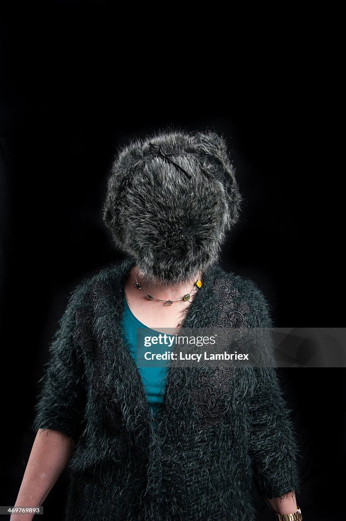 Woman wearing a fake fur hat on her face