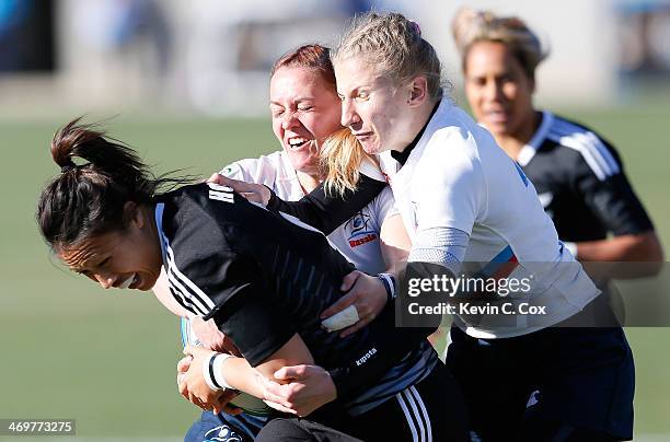 Marina Petrova and Anna Prib of Russia tackle Carla Hohepa of New Zealand during the Women's Sevens World Series at Fifth Third Bank Stadium on...