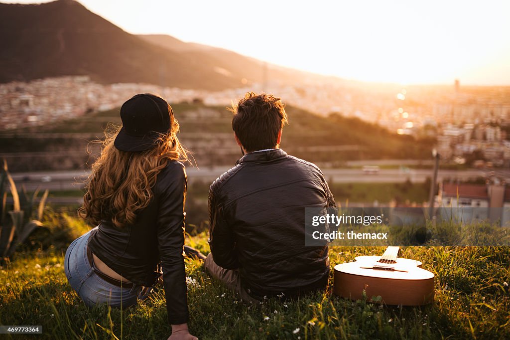 Cute young couple looking sunset