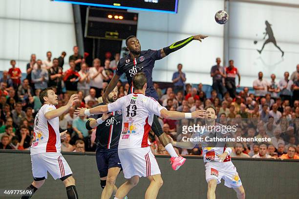 Luc Abalo of Paris Saint-Germain Handball tries to pass the ball against Mirsad Terzic, Momir Ilic and Gergo Ivancsik of MKB-MVM Veszprem during the...
