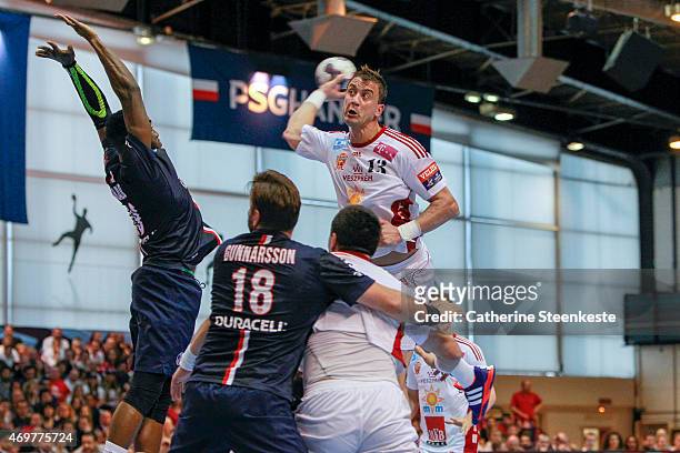 Momir Ilic of MKB-MVM Veszprem shoots the ball against Luc Abalo of Paris Saint-Germain Handball during the EHF Men's Champions League Quarter Final...