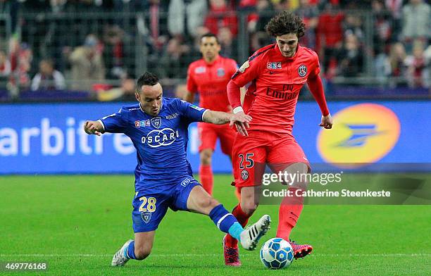 Adrien Rabiot of Paris Saint-Germain FC battles for the ball against Gael Danic of SC Bastia during the French League Cup Final game between SC...