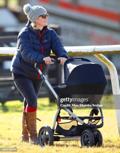 Zara Phillips pushes her baby daughter Mia Tindall in her pushchair as she attends the Barbury Castle Point-to-Point race meeting at Barbury...