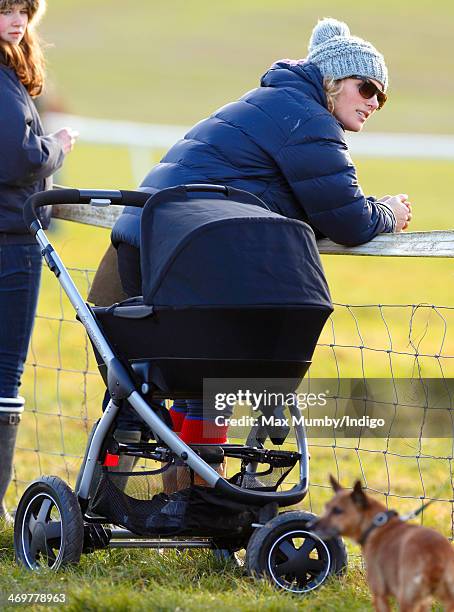 Zara Phillips watches the racing as she and her baby daughter Mia Tindall attend the Barbury Castle Point-to-Point race meeting at Barbury Racecourse...