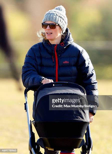 Zara Phillips pushes her baby daughter Mia Tindall in her pushchair as she attends the Barbury Castle Point-to-Point race meeting at Barbury...