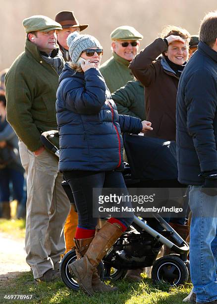 Zara Phillips watches the racing as she and her baby daughter Mia Tindall attend the Barbury Castle Point-to-Point race meeting at Barbury Racecourse...