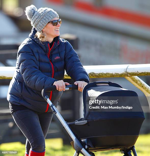 Zara Phillips pushes her baby daughter Mia Tindall in her pushchair as she attends the Barbury Castle Point-to-Point race meeting at Barbury...