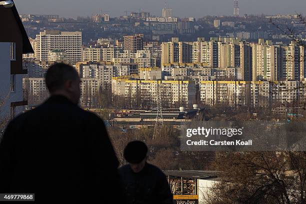 People walk on the street in front of the panorama of the city on March 16, 2015 in Chisinau, Moldova. About 3.5 million inhabitants, the Republic of...