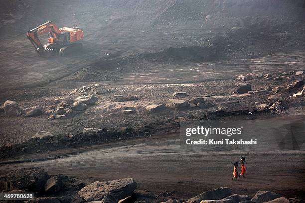 Local villagers carry scavenged coal from an open-cast coal mine in Dhanbad, Jharkhand, India on December 5 tying to earn a few dollars a day. Indian...