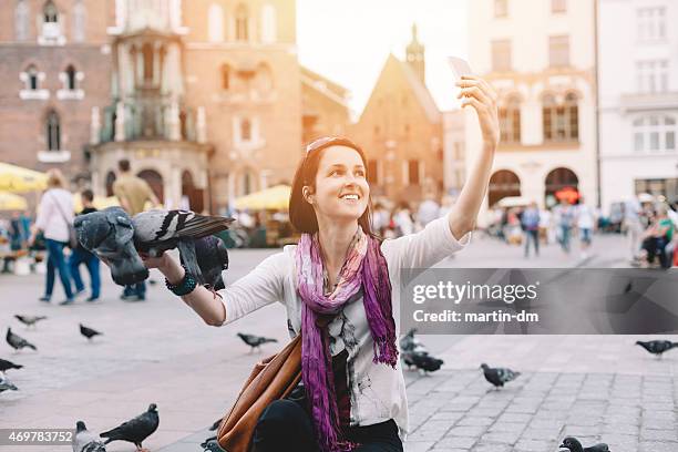 girl with pigeons taking a selfie in krakow - gdansk i stock pictures, royalty-free photos & images