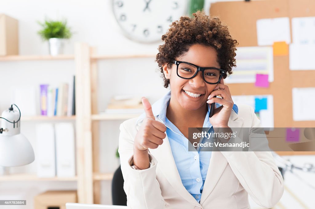 Beautiful cheerful young woman at office