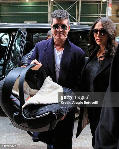 Simon Cowell with his partner Lauren Silverman and newborn son Eric Cowell are seen arriving at their hotel on February 16, 2014 in New York City.