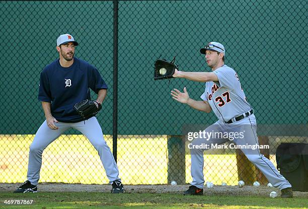 Justin Verlander and Max Scherzer of the Detroit Tigers work on the rag ball fielding drill during the spring training workout day at the TigerTown...