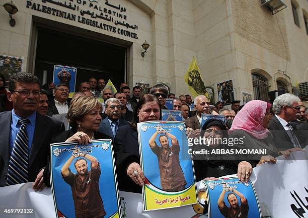 Fadwa Barghuti , the wife of jailed Palestinian Fatah leader Marwan Barghuti, holds a placard bearing his portrait, during a march to mark the...
