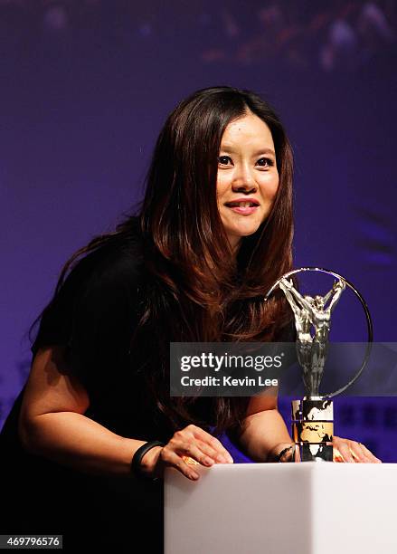 Tennis player Li Na of China poses with her Laureus Academy Exceptional Achievement award at the winners photocall during the 2015 Laureus World...