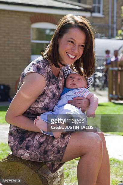 The Labour Party's prospective parliamentary candidate for Ashfield, Gloria De Piero, holds a baby during a visit to Stockwell Gardens Nursery on a...
