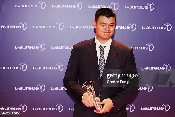 Former Basketball player Yao Ming of China with his Laureus Spirit of Sport award at the winners photocall during the 2015 Laureus World Sports...