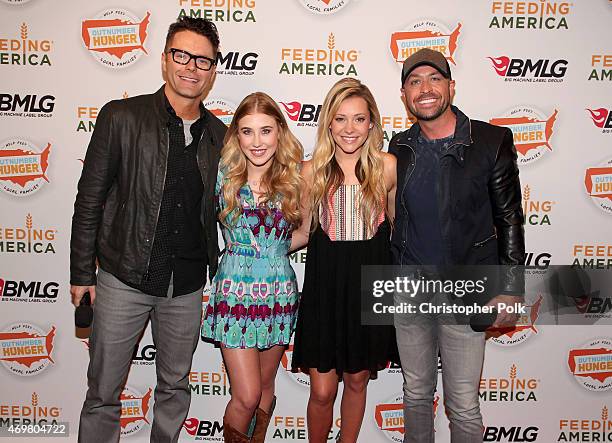 Madison Marlow and Taylor Dye of the musical duo Maddie and Tae pose with iHeart's Bobby Bones and CMT's Cody Alan at the "Reba and Friends Outnumber...