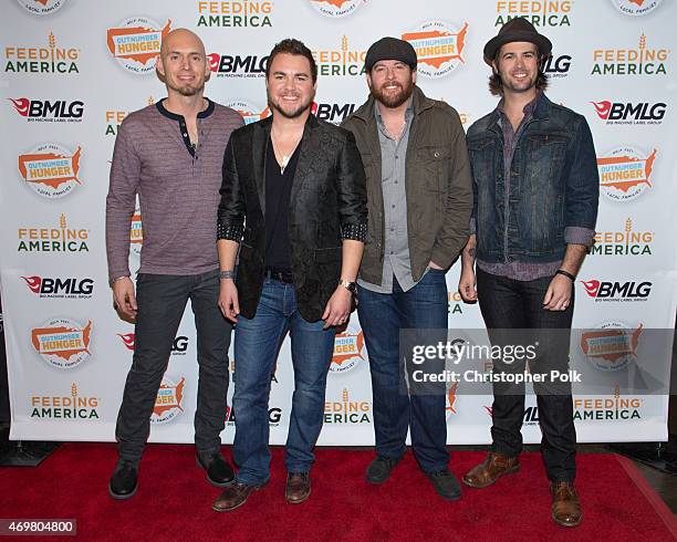 Musicians Jon Jones, Mike Eli, James Young and Chris Thompson of the Eli Young Band pose at the "Reba and Friends Outnumber Hunger" concert event on...