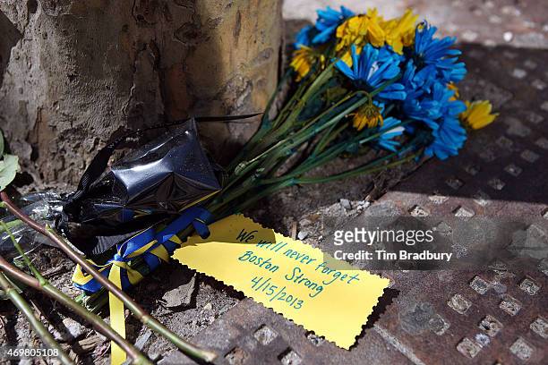 Detailed view of flowers placed on a sidewalk on Boylston Street commemorating the two-year anniversary of the 2013 Boston Marathon bombings, on...