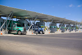 Semi trucks pay at tollbooth at Canadian border
