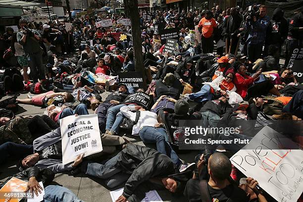 Low wage workers, many in the fast-food industry, join with supporters for a "die-in" in front of a McDonald's to demand a minimum wage of $15 an...