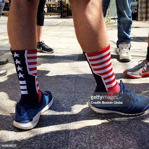 Matt Pearson wears patriotic socks and stands on the spot where Celeste Corcoran was standing on the sidewalk with her family on April 13, 2013....