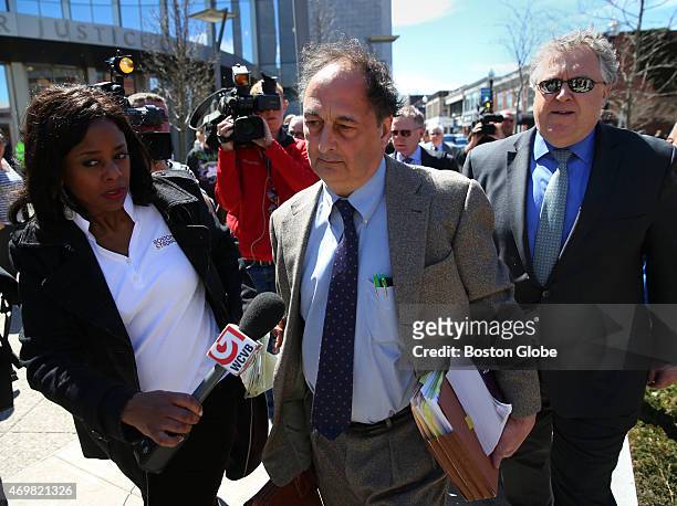 Aaron Hernandez's defense attorneys James Sultan, front, and Michael Fee, rear, left court without taking questions after their client was convicted...