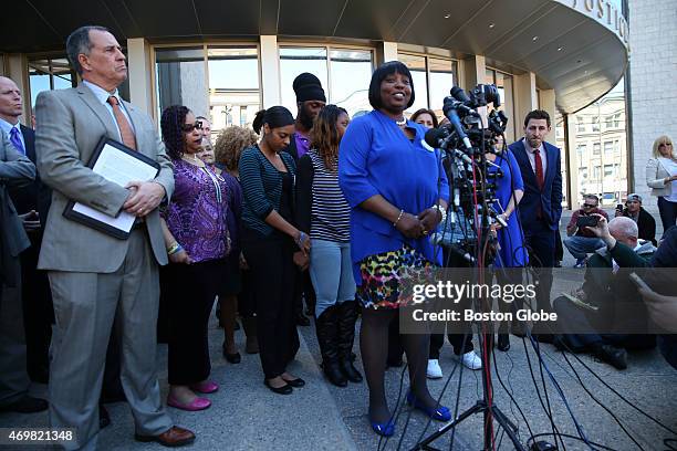 Bristol County District Attorney Thomas Quinn, left, listens as Ursula Ward, the mother of Odin Lloyd, speaks to the media after Aaron Hernandez was...