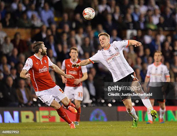 Matt Smith of Fulham is watched by Kirk Broadfoot of Rotherham United during the Sky Bet Championship match between Fulham and Rotherham United at...