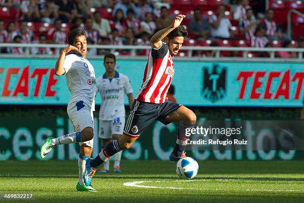 Rafael Marquez of Chivas competes for the ball with Christian Bermudez of Queretaro during the match between Chivas and Queretaro as part of the...