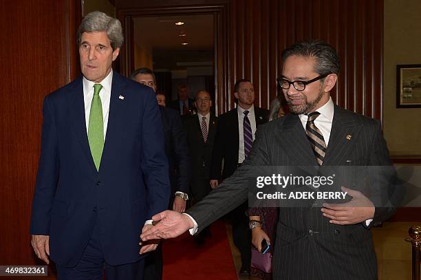Indonesian Foreign Minister Marty Natalegawa ushers US Secretary of State John Kerry before the US-Indonesia fourth Joint Commision Meeting at the...