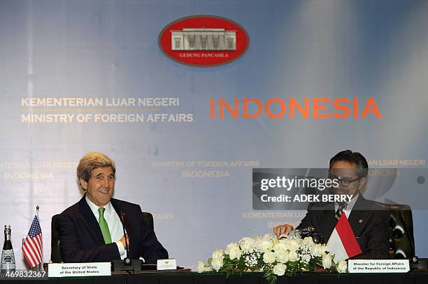 Indonesian Foreign Minister Marty Natalegawa sits next to US Secretary of State John Kerry during the US-Indonesia fourth Joint Commision Meeting at...