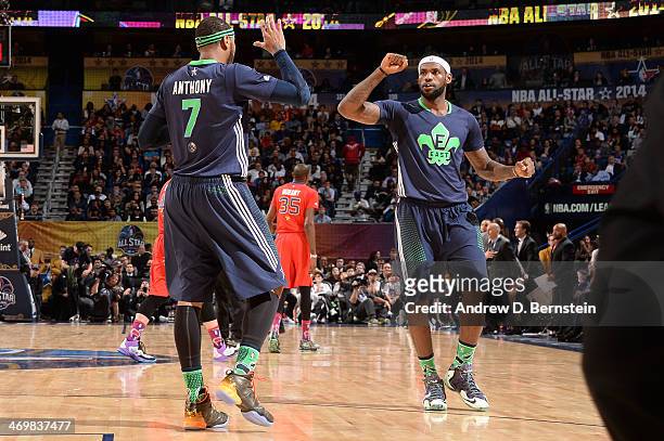 Carmelo Anthony and LeBron James of the Eastern Conference All-Stars high five during the 2014 NBA All-Star Game as part of the 2014 All-Star Weekend...