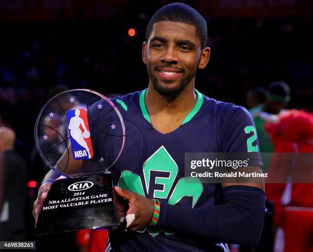 The Eastern Conference's Kyrie Irving of the Cleveland Cavaliers celebrates with the Kia NBA All-Star Game MVP trophy after the 2014 NBA All-Star...