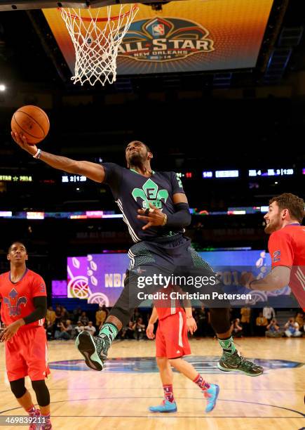 The Eastern Conference's Kyrie Irving of the Cleveland Cavaliers heads for the net as the Western Conference's Kevin Love of the Minnesota...