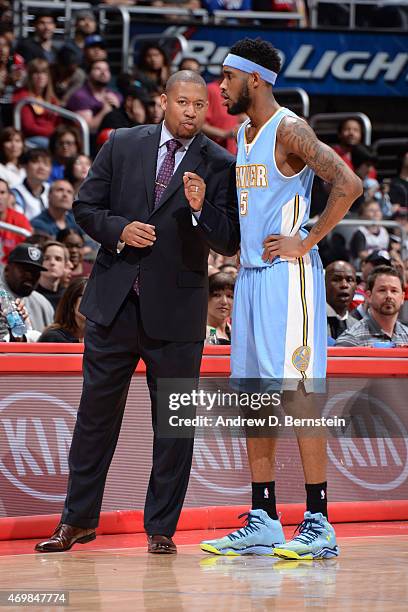 Melvin Hunt and Will Barton of the Denver Nuggets speak during a game against the Los Angeles Clippers on April 13, 2015 at STAPLES Center in Los...