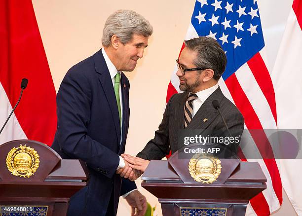 Secretary of State John Kerry shakes with Indonesian Foreign Minister Marty Natalegawa during a news conference at the Pancasila in Jakarta on...