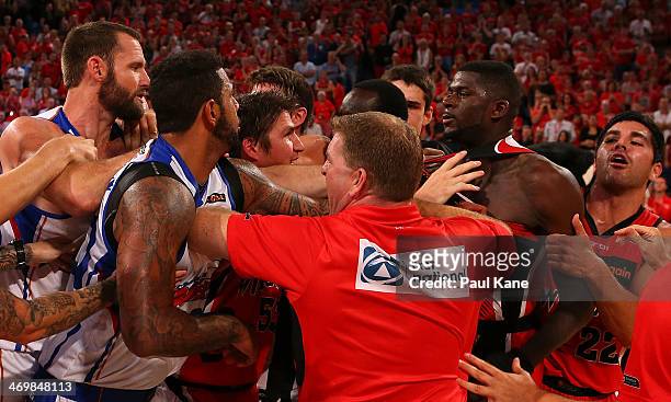 Trevor Gleeson, coach of the Wildcats and Damian Martin attempt to seperate James Ennis and Anthony Petrie and BJ Anthony of the 36ers as players and...
