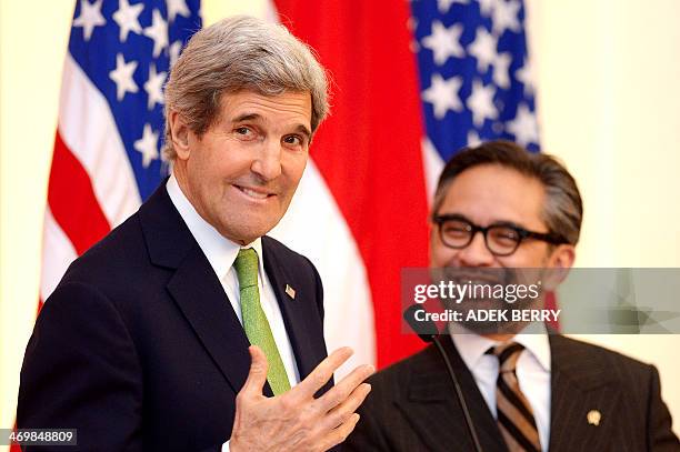Secretary of State John Kerry gestures during a news conference with Indonesian Foreign Minister Marty Natalegawa at the Pancasila in Jakarta on...