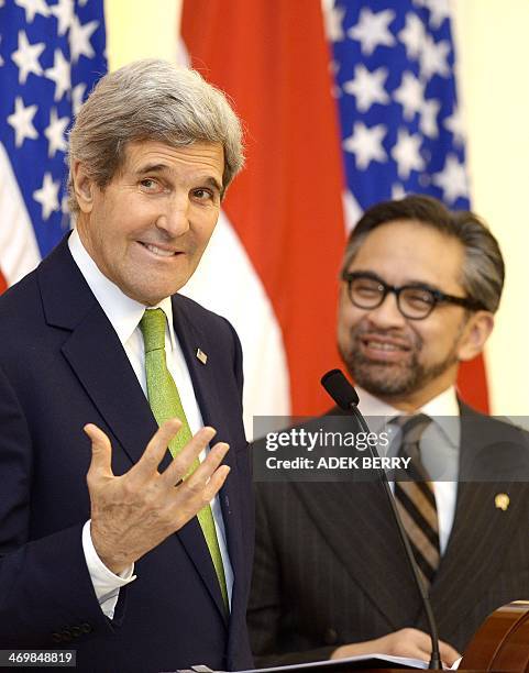 Secretary of State John Kerry gestures during a news conference with Indonesian Foreign Minister Marty Natalegawa at the Pancasila in Jakarta on...