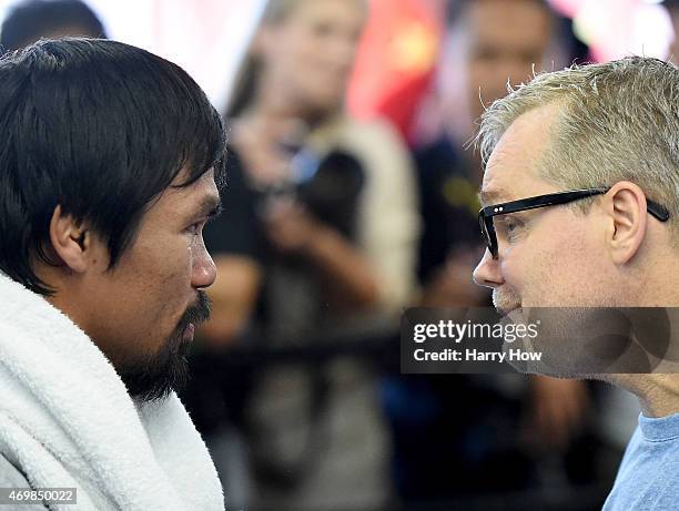 Manny Pacquiao and trainer Freddie Roach speak before a workout in preparation for his fight against Floyd Mayweather Jr. At Wild Card Boxing Club on...