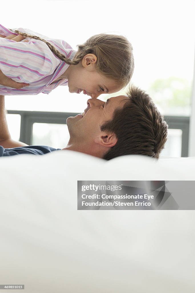 Father and daughter on bed