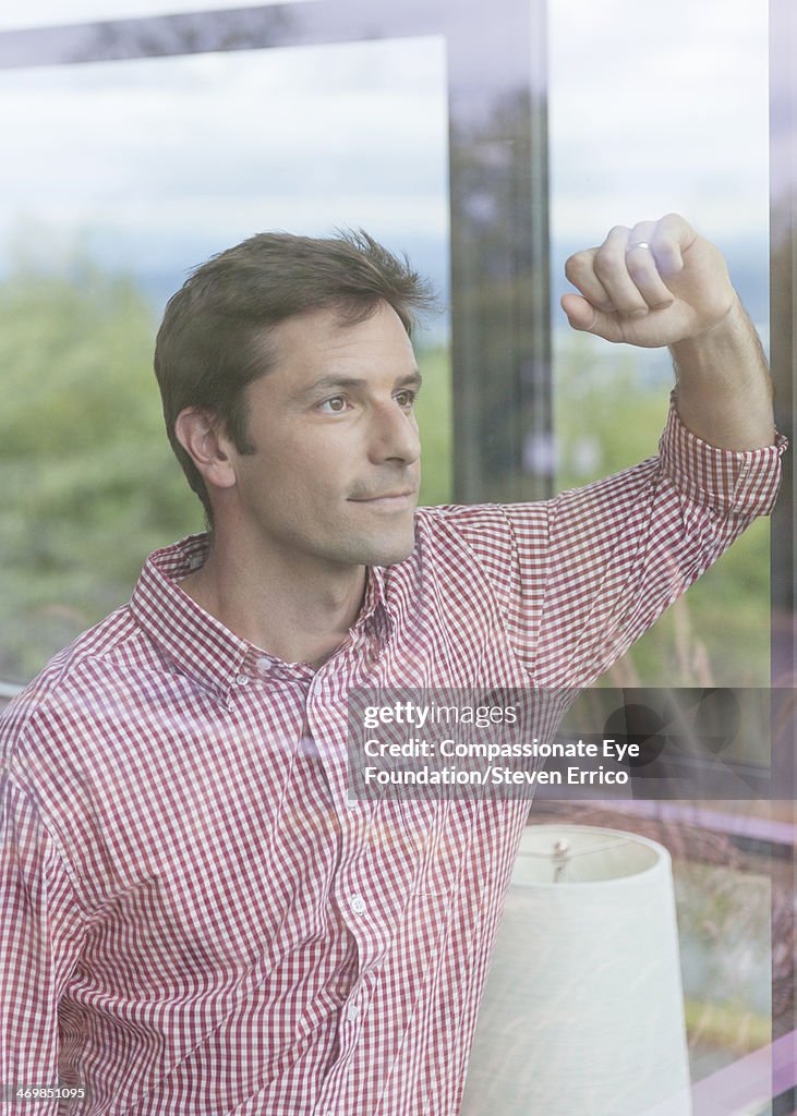 Close up of man in living room by window