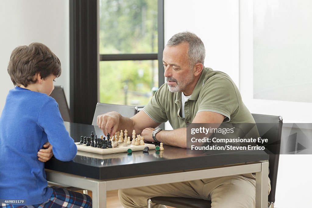 Grandfather and grandson playing chess