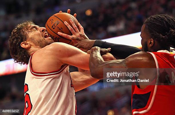 Pau Gasol of the Chicago Bulls is fouled by DeMarre Carroll of the Atlanta Hawks at the United Center on April 15, 2015 in Chicago, Illinois. NOTE TO...
