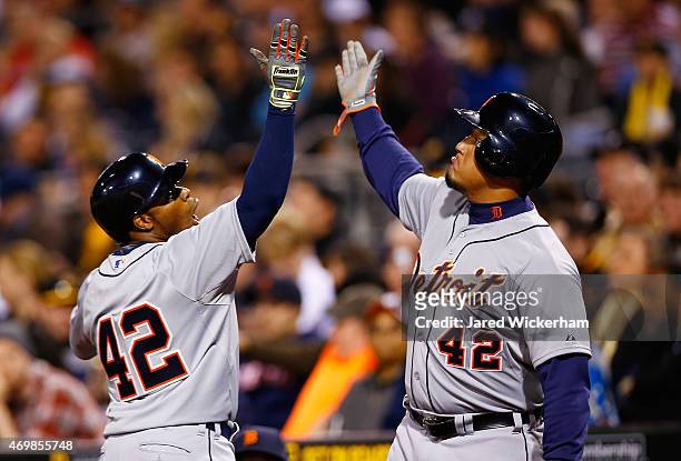 Rajai Davis of the Detroit Tigers celebrates his solo home run against the Pittsburgh Pirates in the sixth inning with teammate Miguel Cabrera while...